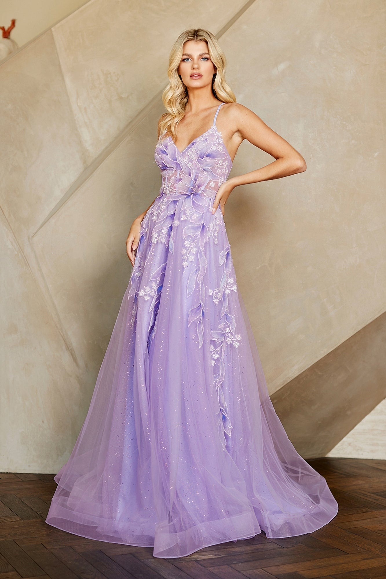 Amelia Couture 4073 long lavender A-line evening gown featuring a sheer bodice, spaghetti straps, and floral and leaf appliques overlaying a glitter tulle skirt.